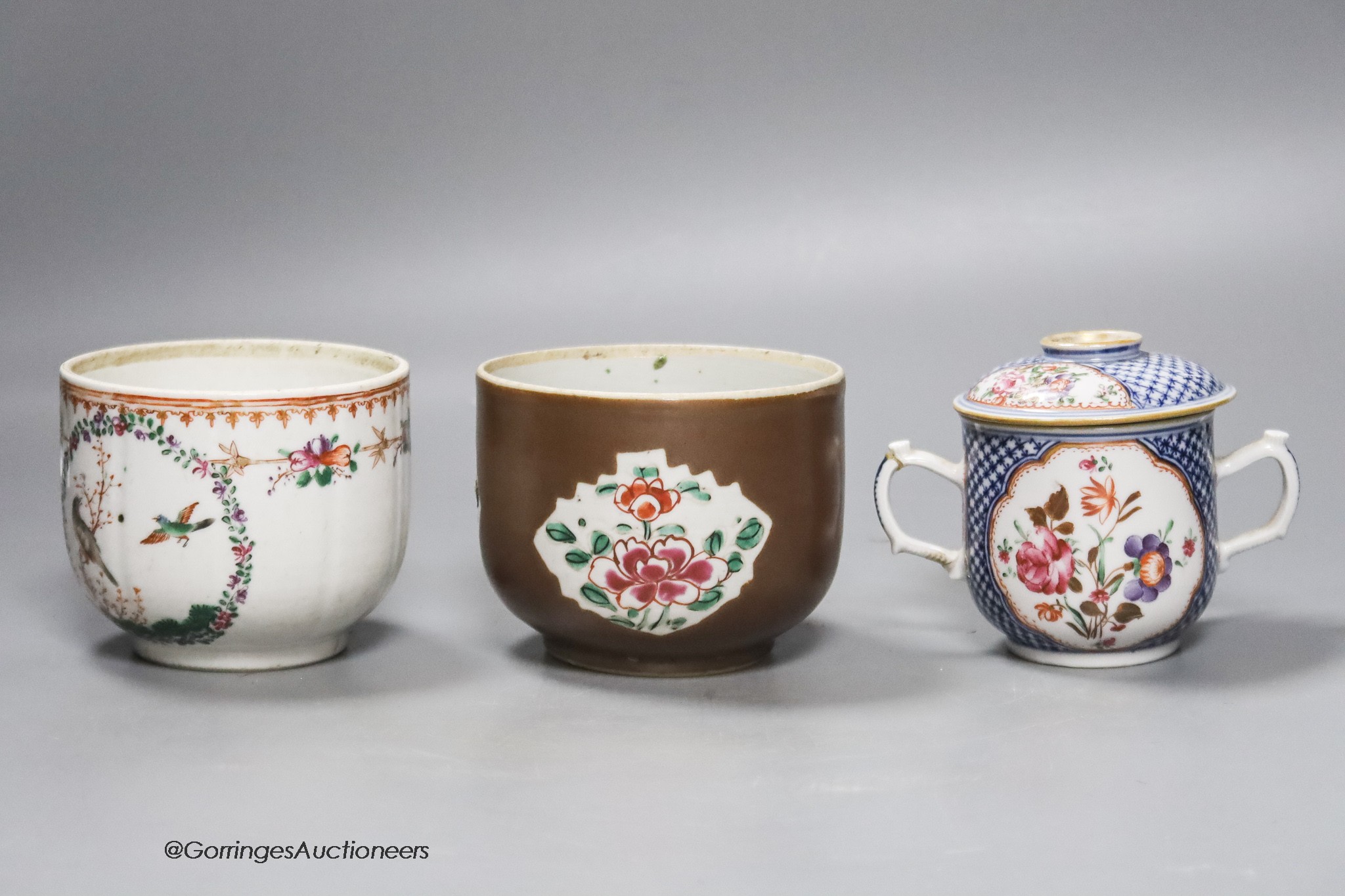 An 18th century Chinese export jar, lacking cover, a similar two handled jar and cover and a brown glazed jar